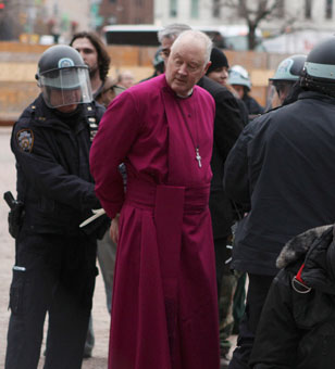 Retired Episcopal Bishop George Packard is detained by police after Occupy Wall Street protesters attempted to use a lot owned by Trinity Church as a camp site, in New York, December 17, 2011.