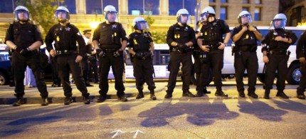 Chicago police officers watch protesters during a demonstration in downtown Chicago on the eve of the NATO summit, 05/19/12. (photo: Getty Images)