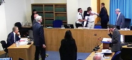 A protester is restrained by security while former British Prime Minister Tony Blair testifies at the Leveson inquiry, 05/28/12. (photo: Reuters TV/Reuters)