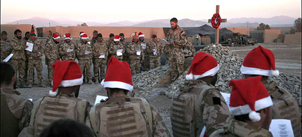 In this 2008 photo, thousands of miles from their loved ones, Royal Marines sing Christmas carols in Afghanistan - moments before Taliban forces staged a surprise attack. (photo: Capt. Euan Goodman)