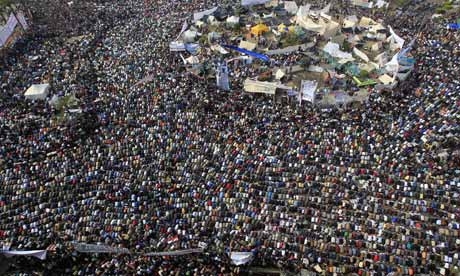 Demonstrators perform Friday prayers at Tahrir square in Cairo