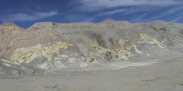 Smoke spewing from holes in the side of Mount Egon