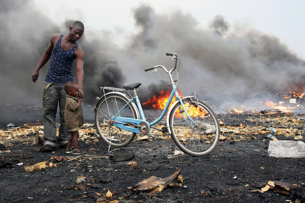 The Agbogbloshie e-Wasteland in Ghana. Fires are set to wires and other electronics to release valuable copper and other materials. The fires blacken the landscape, releasing toxic fumes. Credit: Blacksmith Institute