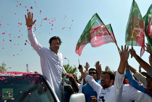Pakistan cricketer turned politician Imran Khan waves to supporters at the start of a rally on the outskirts of Islamabad on October 6, 2012. Khan is leading western peace activists and local loyalists on a highly publicised rally to Pakistan′s tribal belt in protest against US drone strikes.  (AFP Photo/A Majeed)