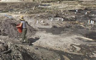 Linda Geary of the Archaeological and Historical Conservancy works on the removal of soil at the site of the MetSquare dig to expose the foundation of the historical Tequesta Indian structures that stood there.