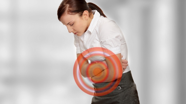 A woman experiences stomach pain. Photo: Shutterstock.com, all rights reserved. A woman experiences stomach pain. Photo: Shutterstock.com, all rights reserved.