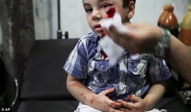 Upsetting: These pictures show wounded children being treated at the Dar al-Shifa hospital following a deadly attack by government forces